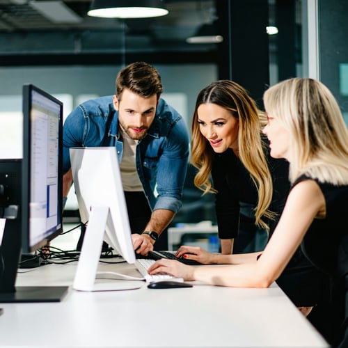 photograph of an office team working together with computer photograph of an office team working together with computer