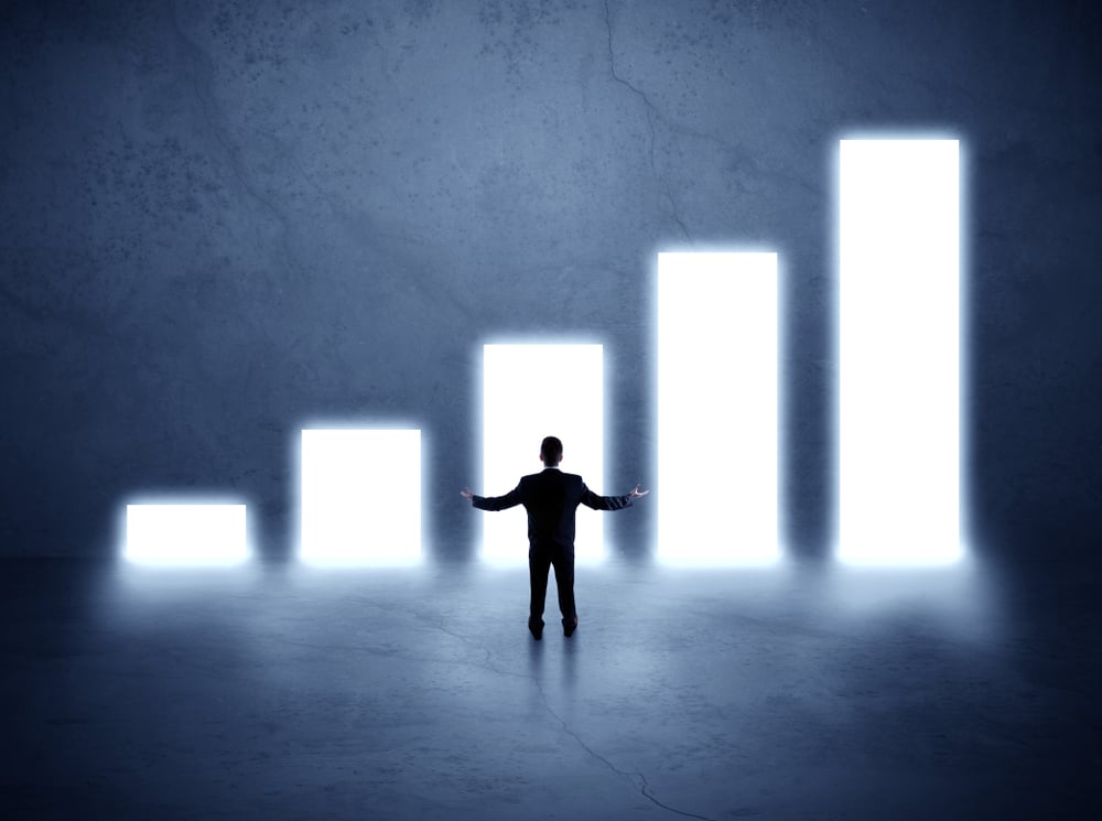 Businessman standing in the front of growth chart of profits