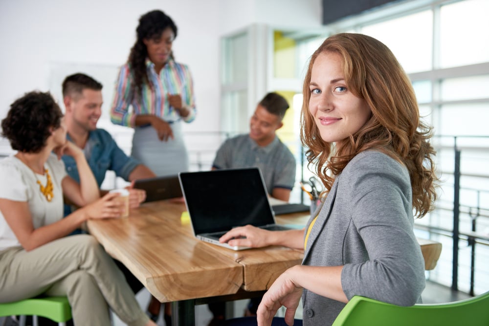 Image of a succesful casual business woman using laptop during meeting-4