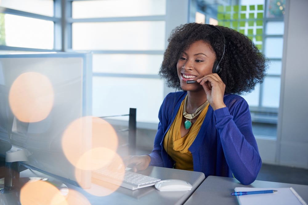 Portrait of a smiling customer service representative with an afro at the computer using headset-Dec-31-2024-01-53-39-6212-PM