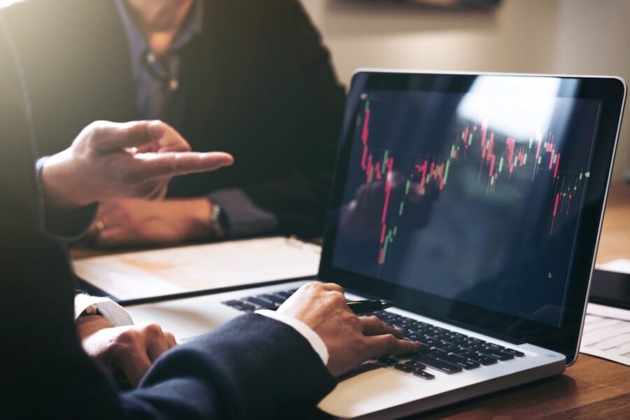 business meeting looking at financial report graph laptop