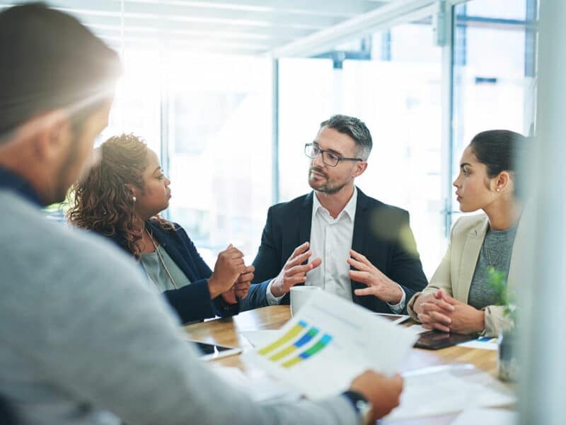 coworkers in meeting business continuity bank graphs-1