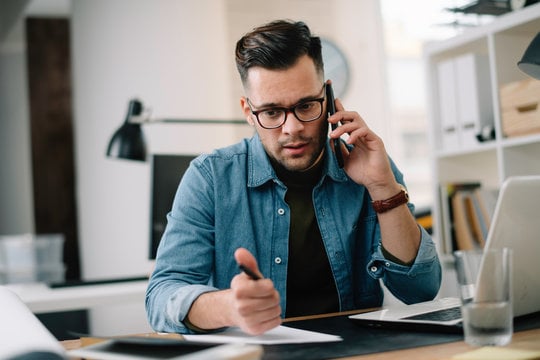 man talking on phone concerned